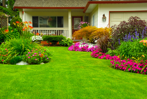 Manicured House and Garden displaying annual and perennial gardens in full bloom.