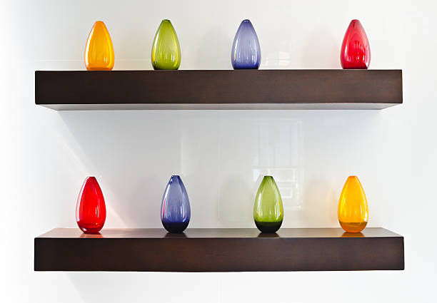 istock Colorful glass bottles on wooden shelf 149360200