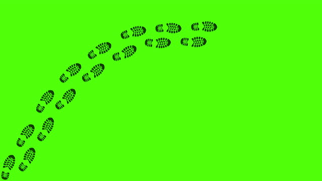 Trail of human footprints on green screen background. Black silhouettes of human shoeprints. Steps tracing the human path. Journey of the footsteps. Step by step.