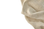 Rough beige linen napkin isolated on white background. Top view with copy space
