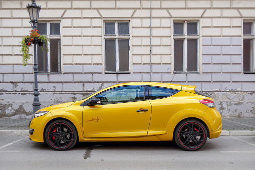 Yellow 3 door hot hatchback - Renault Megane R.S. Trophy is parked in Novi Sad, Serbia 31.08.2022