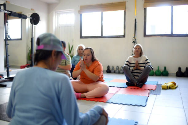 istock people doing yoga in a gym 1493603763