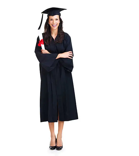 Happy young graduate smiles at the camera with her arms folded - portrait
