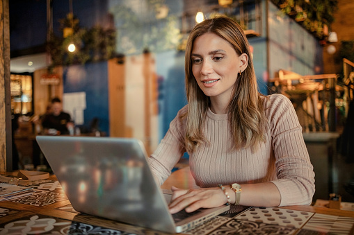 Double Exposure of Female Freelancer Working Remotely on Laptop Computer in Cafe. Online Remote Work in Coffeeshop