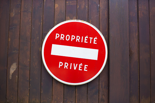 France: Old Red Sign on Wood Door Reading 