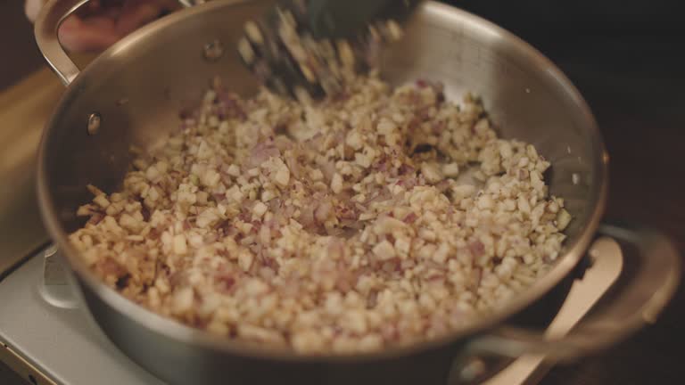 frying chopped onion, aubergine together