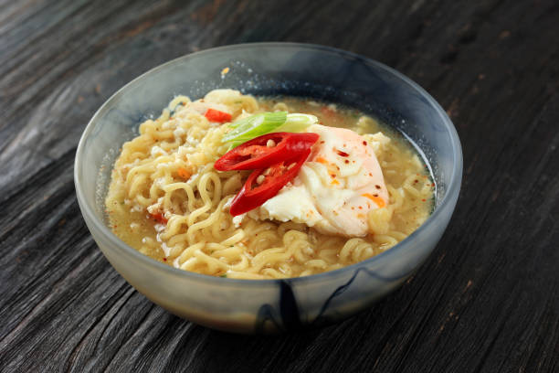 istock Spicy Instant Noodle Soup with Poached Egg, Green Onion, and Sliced Chilli. 1493613094