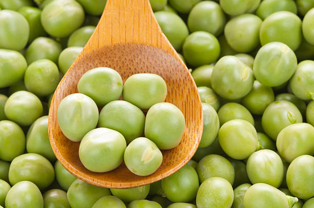 istock Fresh grren peas on wooden spoon 149361824