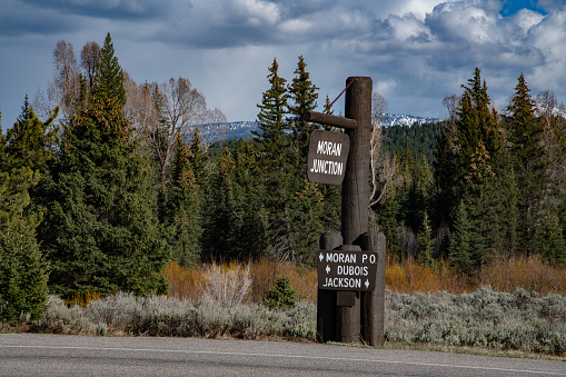 Highway information sign at Moran Junction in the Yellowstone Ecosystem in western USA and North America. Nearest cities are Gardiner, Cooke City, Bozeman, Billings, Montana, Jackson, Wyoming, Salt Lake City, Utah and Denver, Colorado.