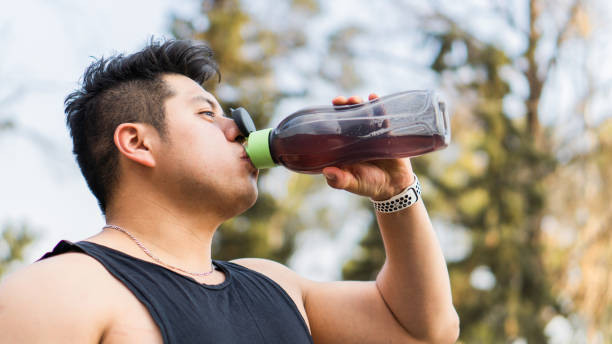 istock Latino man drinking water in a bottle after exercise routine. Lifestyle. 1493621944