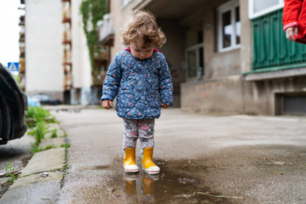 istock Little girl playing at rainy day 1493623920