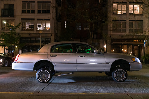 Seattle, USA - May 6th, 2023: A low rider car club on Pike Street on Capitol Hill late in the evening.