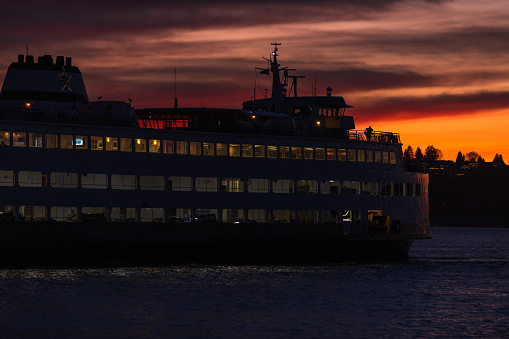 Sunset over Elliott Bay as a ferry crosses.