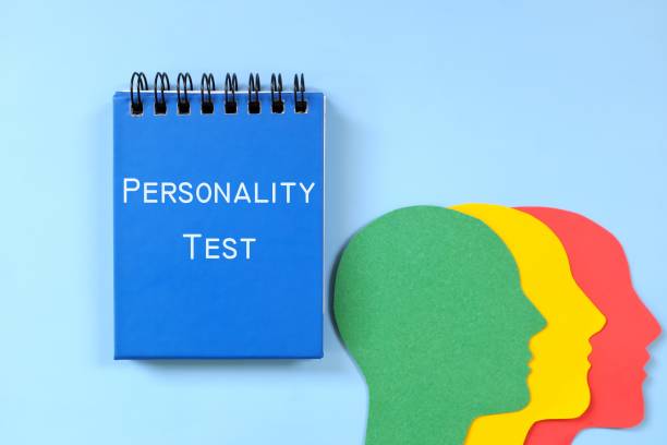 Personality test concept. Word written on blue notepad with human head profile silhouette. Personality test concept. Word written on blue notepad with human head profile silhouette. personality test stock pictures, royalty-free photos & images