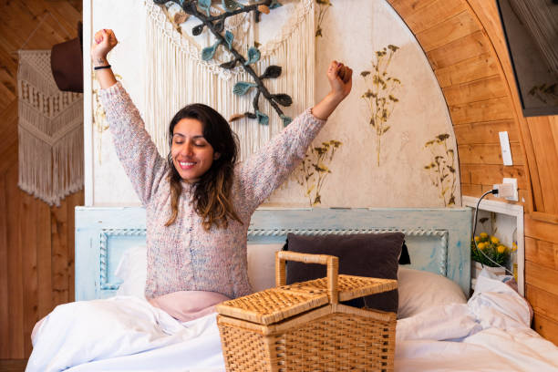 Breakfast Surprise: Latina Woman's Expression of Amazement in a Cozy Country Home Latina woman sits on a cozy bed in a charming country house, her face displaying a delightful expression of surprise unusual basket stock pictures, royalty-free photos & images
