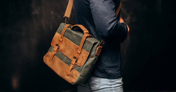 istock Man with duffle bag on shoulder. leather and canvas bag 1493644517
