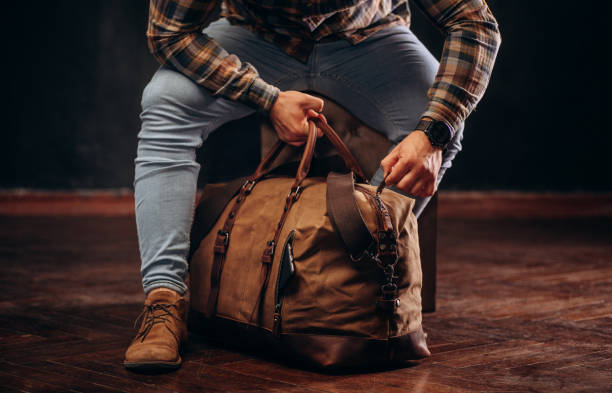 istock Man hold brown shoulder canvas bag in hand 1493644524