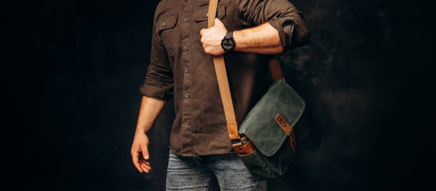 istock Man with duffle bag on shoulder. leather and canvas bag 1493644548