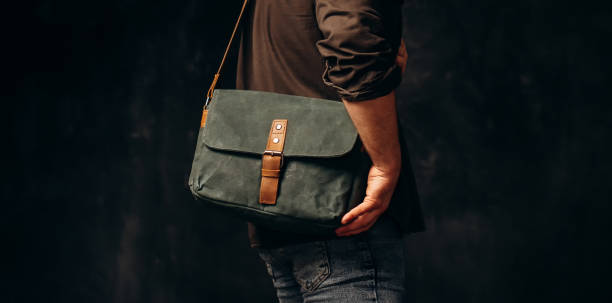 istock Man with duffle bag on shoulder. leather and canvas bag 1493644559
