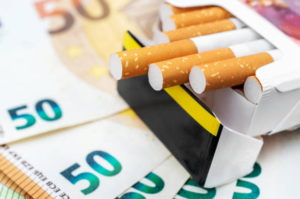 Pack of cigarettes on the euro bills. Close up. stock photo
