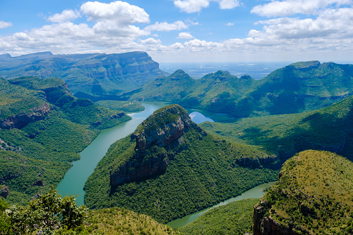 Panorama Route South Africa, Blyde river canyon with the three rondavels, view of three rondavels with a blue sky and green hills during summer