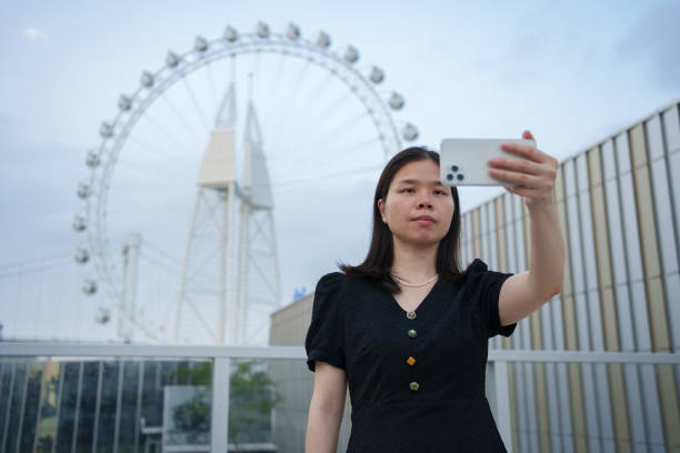 istock Asian woman taking selfie with smartphone 1493646799