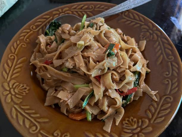 istock Stir fry rice noodle served on a brown plate 1493647496