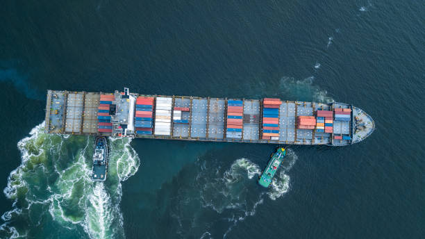 istock Aerial view container ship and tugboat drag shipping to seaport, Container ship load container for global business logistics import export, Freight shipping and transportation. 1493654989