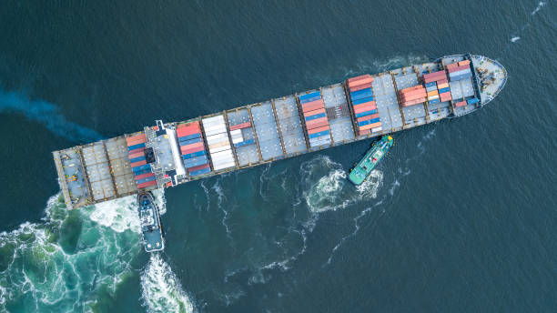 istock Aerial view container ship and tugboat drag shipping to seaport, Container ship load container for global business logistics import export, Freight shipping and transportation. 1493655035