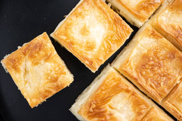 istock Cheesy pastry, butter pastry, top view flat lay, on black dark stone table background 1493665955