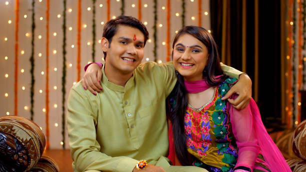 Indian brother and sister sharing love on the occasion of Raksha Bandhan - Festival concept, Indian Model Good looking siblings smiling and showing their brother-sister relationship by hugging each other on Rakhi rakhi stock pictures, royalty-free photos & images