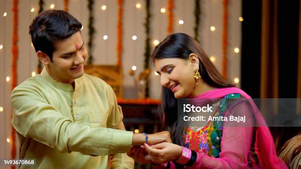 Indian Sister Tying Rakhi On Her Brothers Wrist And Expressing The Love Raksha Bandhan Indian Model Stock Photo - Download Image Now