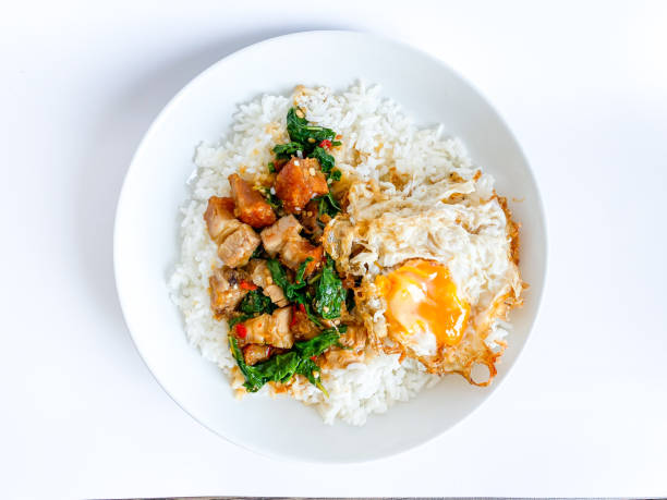 istock Rice topped with crispy pork belly with Thai basil and fried egg 1493670942