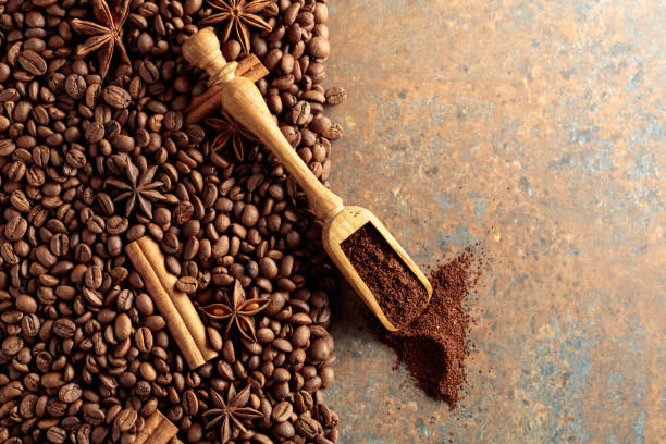 istock Ground coffee in a spoon and coffee beans with cinnamon and anise on a rusty metal background. 1493676800