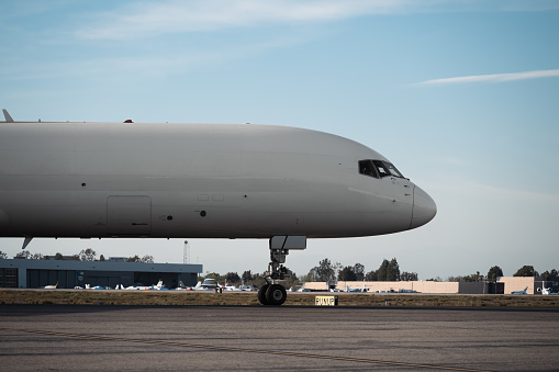 A massive cargo plane advances along the runway, showcasing its sheer size and power.