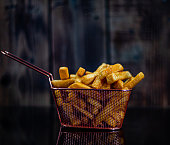 French fries in a metal basket on table
