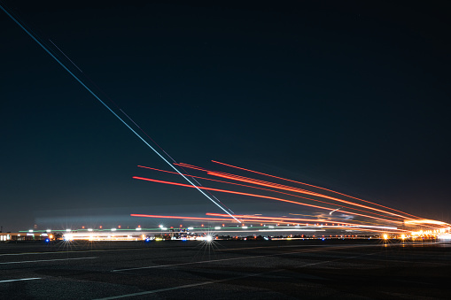 The radiant glow emanates as the aircraft takes off, leaving behind a mesmerizing trail of light in its wake.