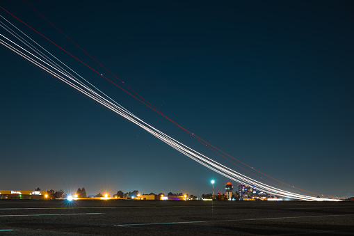 The radiant glow emanates as the aircraft takes off, leaving behind a mesmerizing trail of light in its wake.