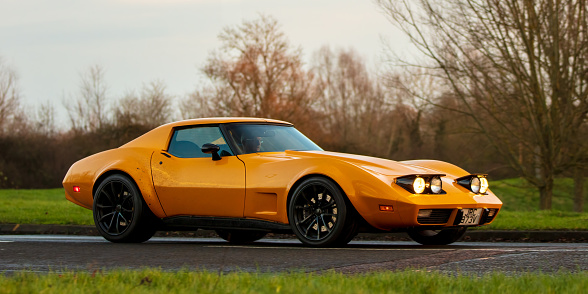 Stony Stratford,Bucks,UK - January 1st 2022.  1976 yellow CHEVROLET CORVETTE   classic car travelling on an English country road