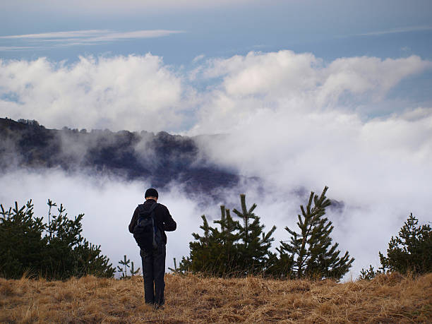 Man standing on a high mountain stock photo