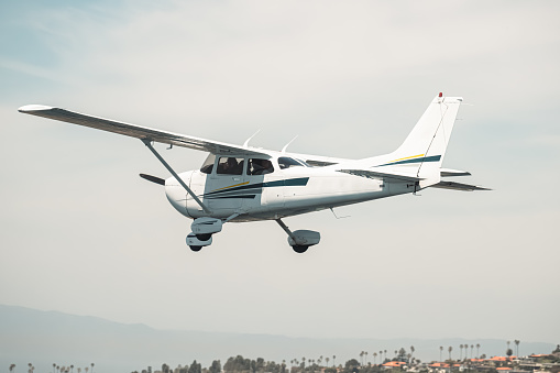 Symmetrical front view of Cessna 172 Skyhawk 2 airplane on an asphalt runway.