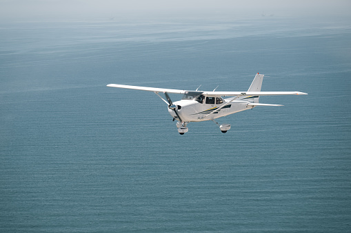 An airplane flying, soaring towards the boundless horizon