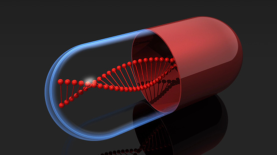 DNA spiral pill on black background. Genetically modified food concept.