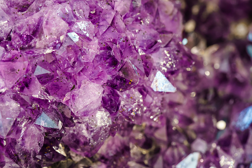 Amethyst over black background, a violet variety of quartz, often used in jewelry. Silica, silicon dioxide, SiO2.