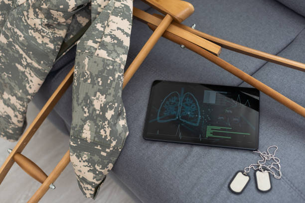 istock military uniform with crutches and a tablet 1493694143