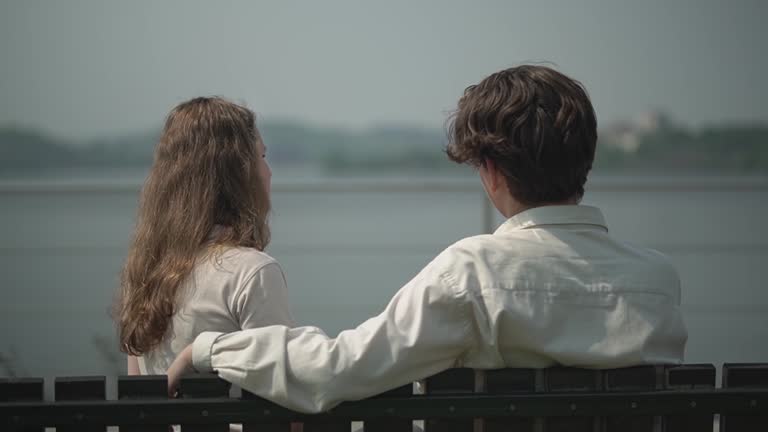 teenagers sitting on a bench