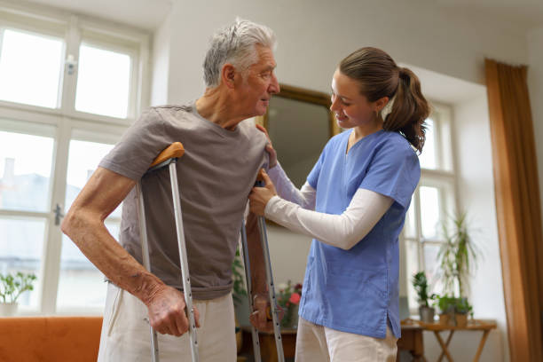 istock Young nurse helping senior man with walking. 1493694384