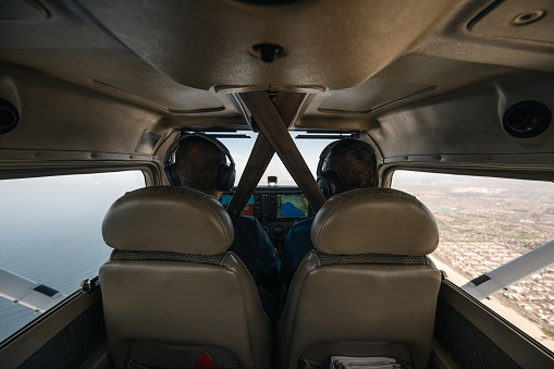 Within the aircraft cabin, panoramic views unfold on both sides, offering glimpses of the bustling cityscape on one side and the vast expanse of the sea on the other, providing passengers with a captivating contrast of urban and maritime vistas.