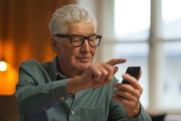 istock Senior man scrolling his smartphone at home. 1493694781