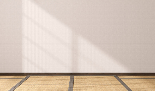Empty Japanese style room with tatami mat floor, wood shoji window in sunlight, grills shadow on white wall for East Asian interior design decoration, architecture, product display background 3D